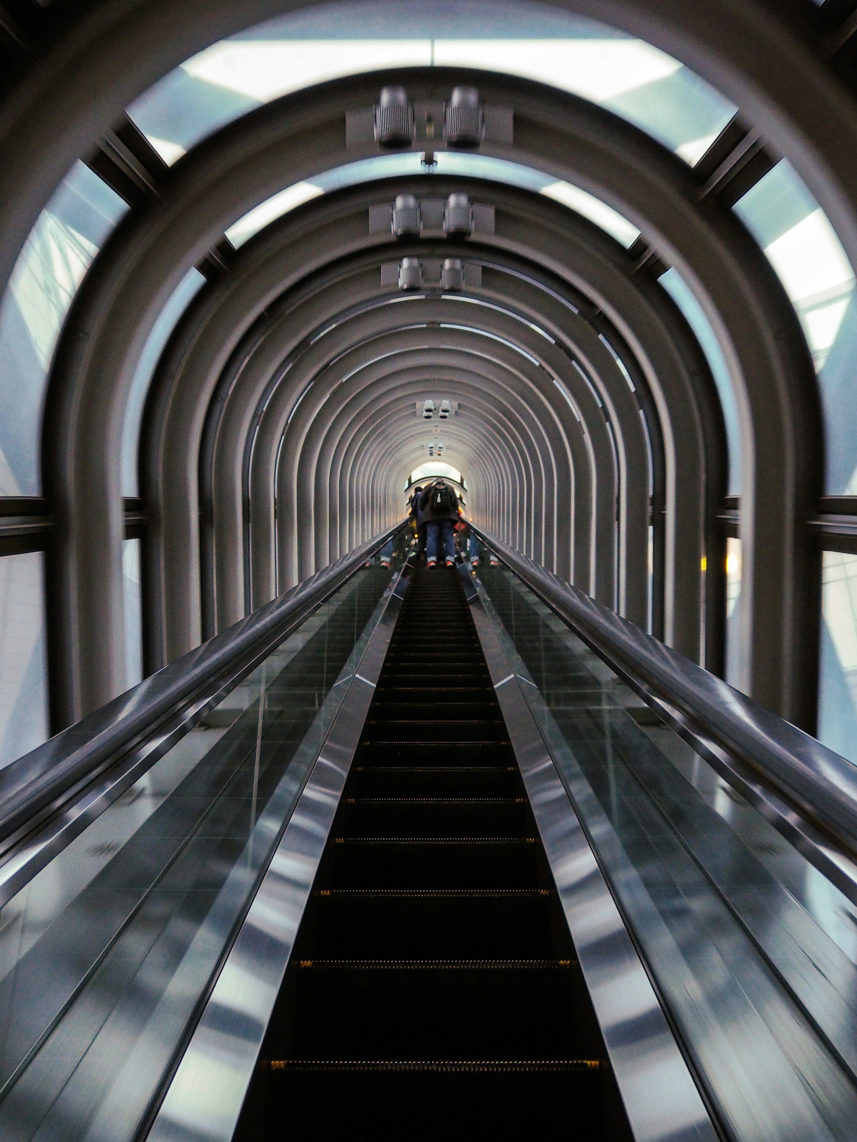 person standing on escalator